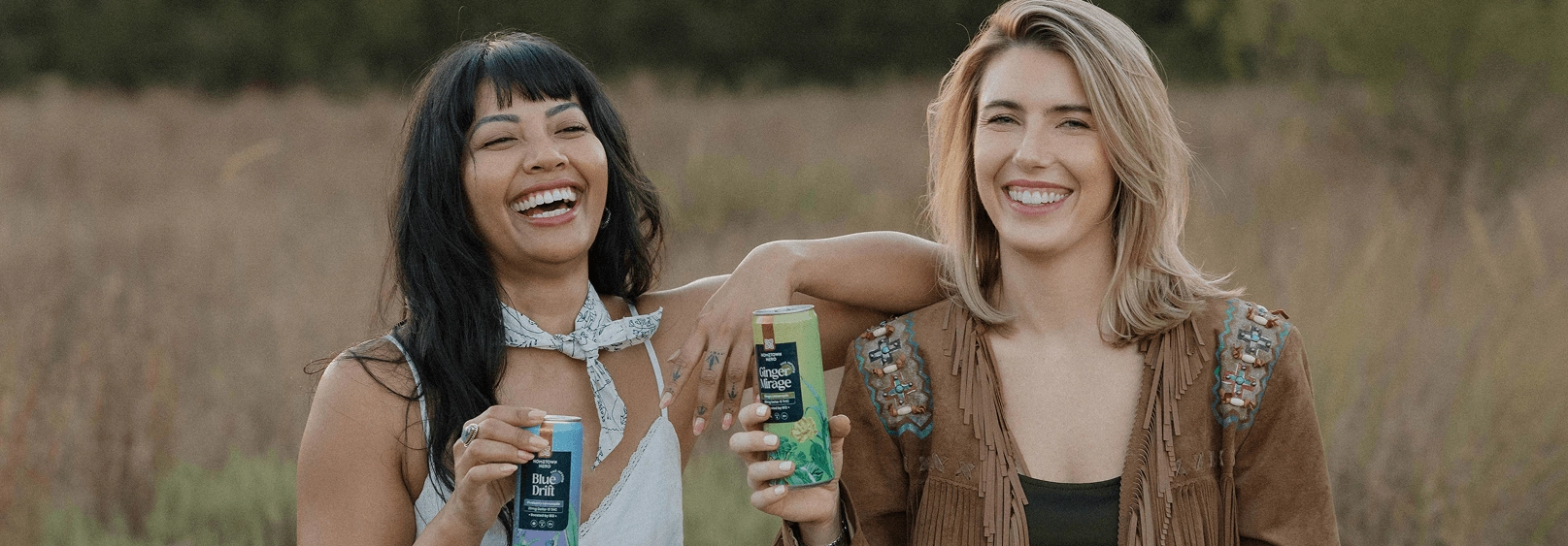 Two friends enjoying Hometown Hero beverages in a Texas field